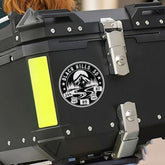 Black storage box with a logo on a motorcycle